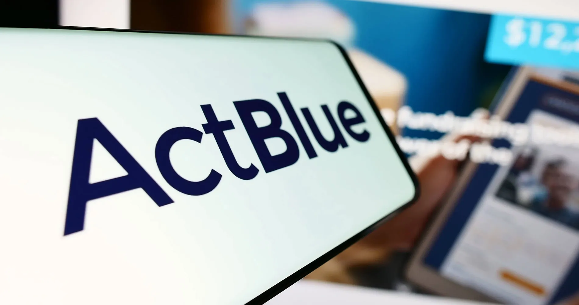 Mobile phone with logo of fundraising organization ActBlue Charities Inc.
