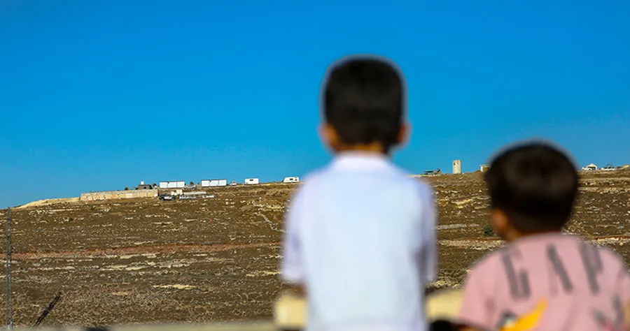 New Outpost on Jabal al-Jumuja Hilltop in Hebron Two Palestinian children stand on a rooftop