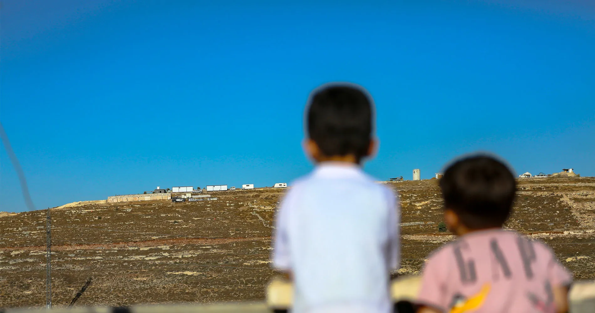 New Outpost on Jabal al-Jumuja Hilltop in Hebron Two Palestinian children stand on a rooftop